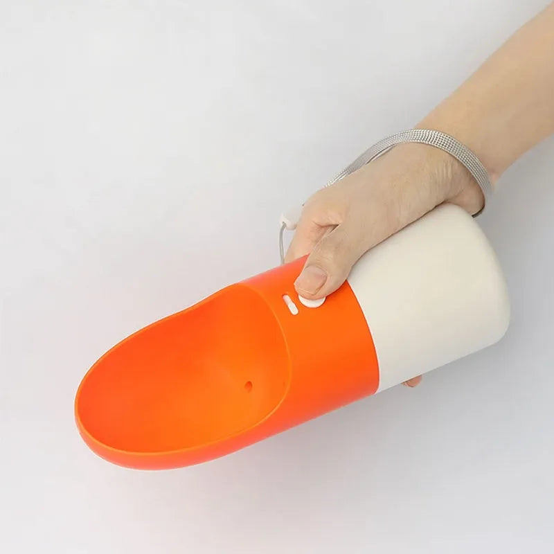 Moestar rocket-shaped pet drinking cup in white with grey accents showing water outlet and lock button