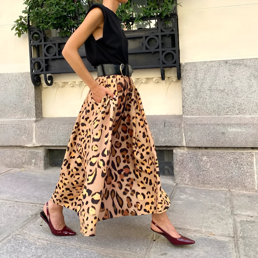 Brown leopard print women's long A-line skirt with a deep hem, shown on a hanger.