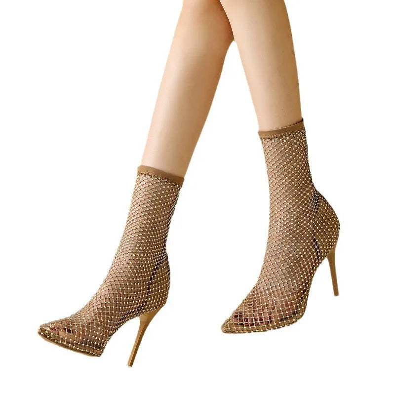 Gold coloured pointed toe stiletto high heel sandals with a mesh upper.