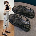 Women's black Roman style platform sandals with a round toe and sleeve design on a white background.