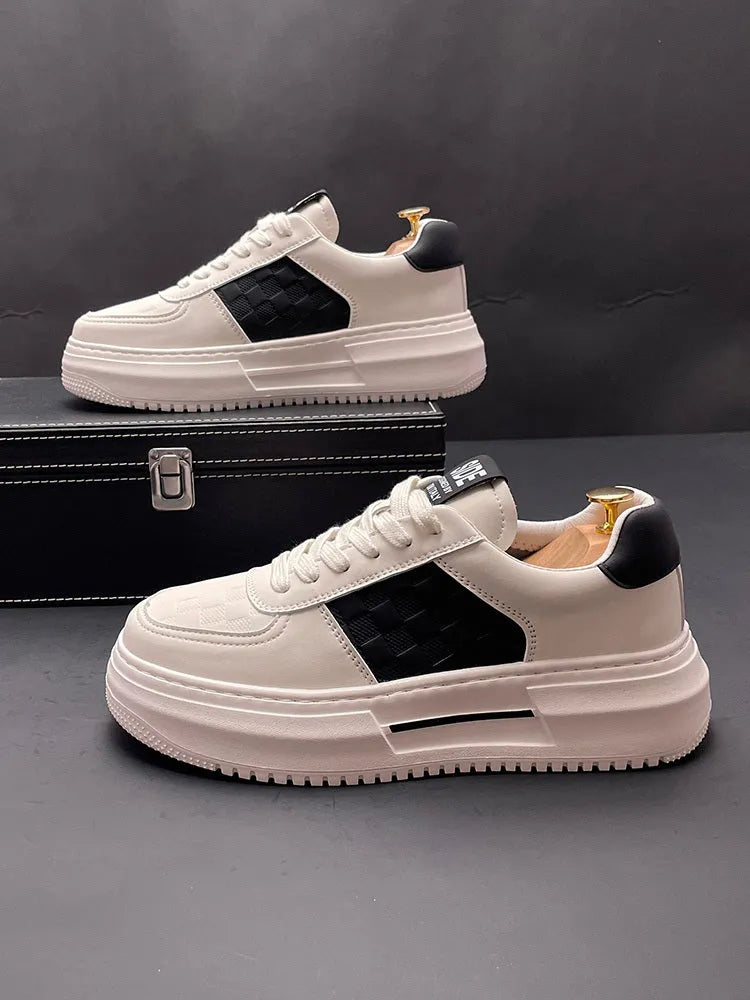 A pair of white, black, and green casual sports shoes with cloth uppers and rubber foam soles.
