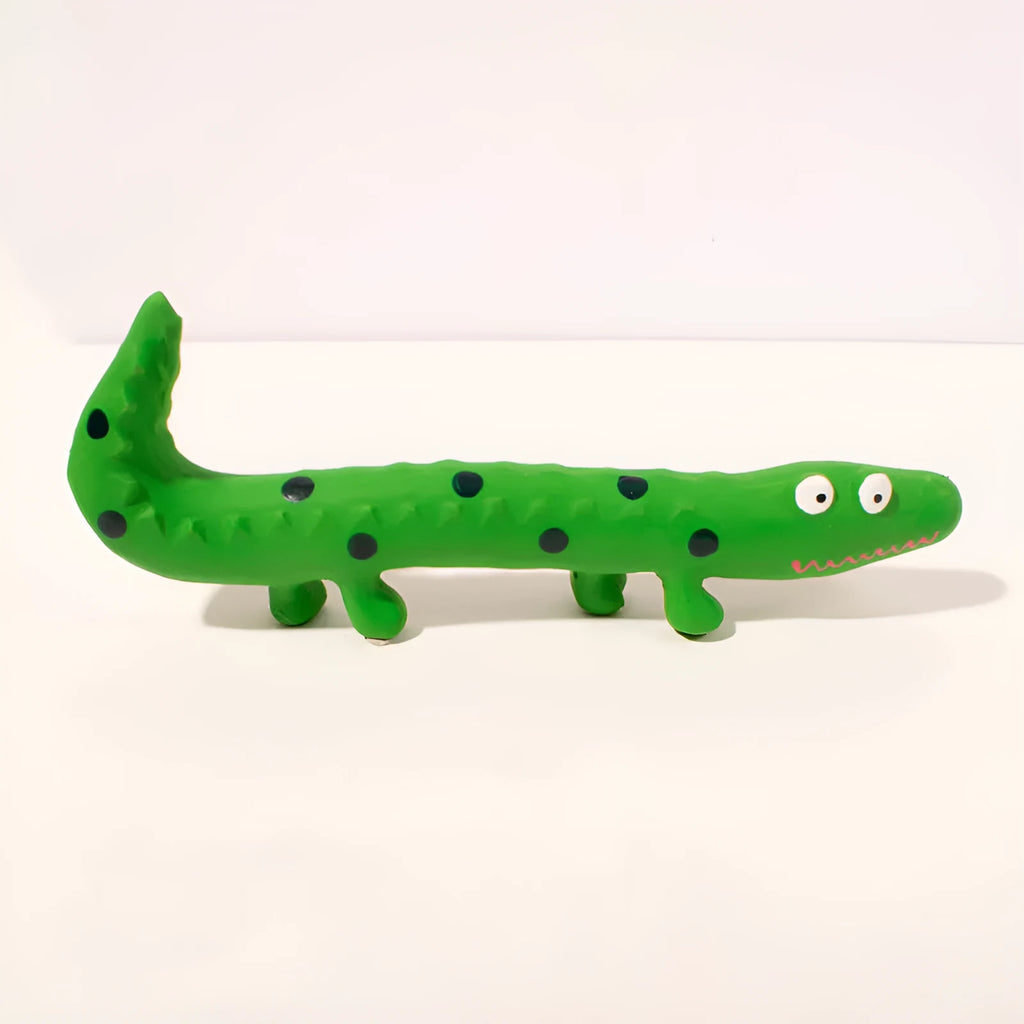Green cartoon lizard shaped latex dog squeaky chew toy on a white background.
