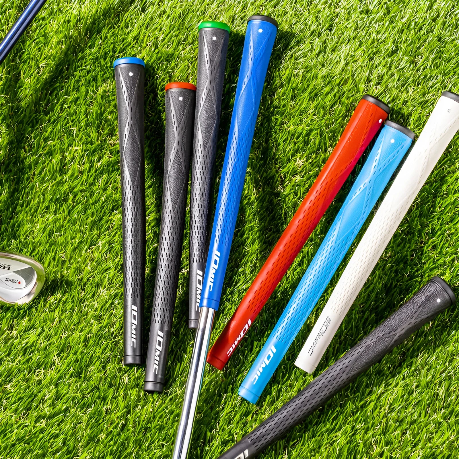 TPE golf club grip in assorted colours including pink, red, and black with blue head on a golf club.