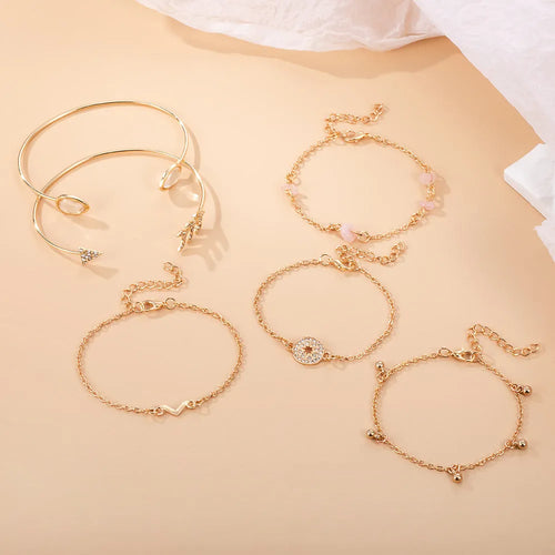 Gold zinc alloy bracelet set with water droplet and V-shaped designs for women.