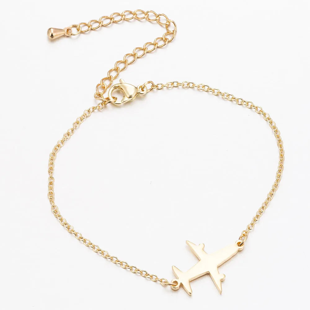 Alloy bracelet with simple airplane pendant in gold colour, unisex style