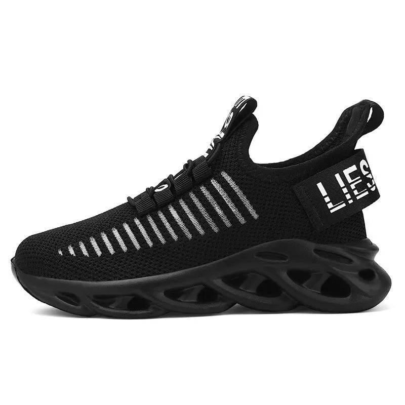 Children's black velcro sneakers with fabric upper and EVA sole on white background