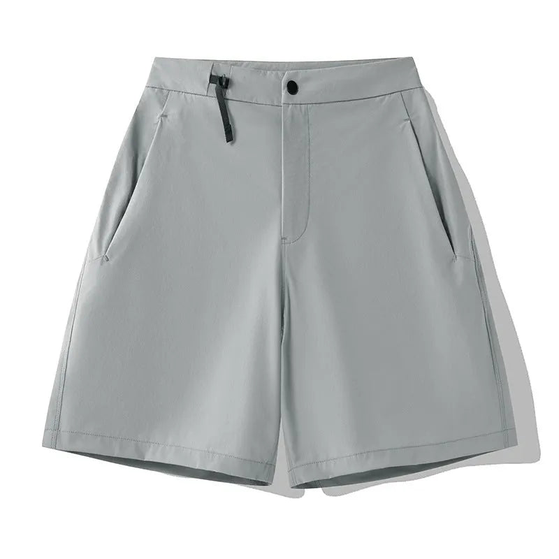 Man wearing khaki 3D cut quick-dry sports shorts with four-way stretch, suitable for running.