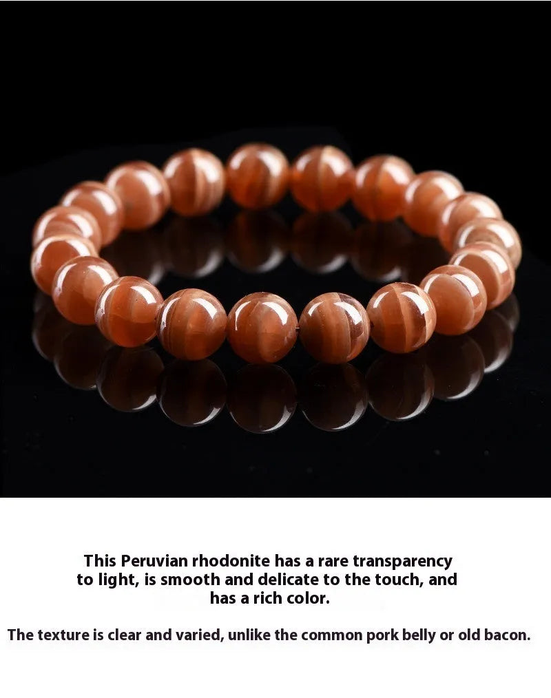 Natural Old Mine Rhodochrosite mineral bracelet with round beads in 6mm or 8mm size on a wrist.