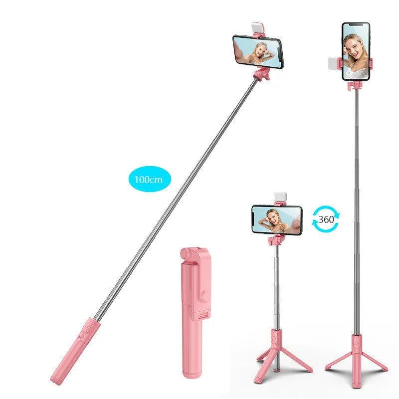Black Bluetooth selfie stick with extended tripod legs and integrated fill light, holding a smartphone.