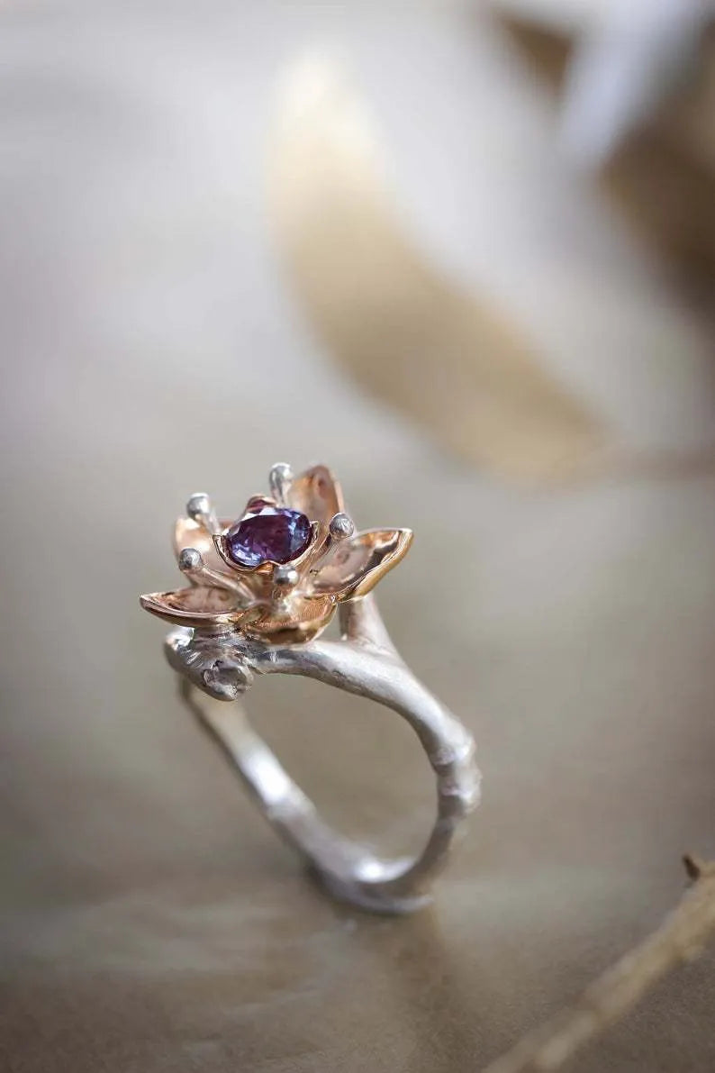 Silver two-tone floral geometric alloy ring for women on a plain background.