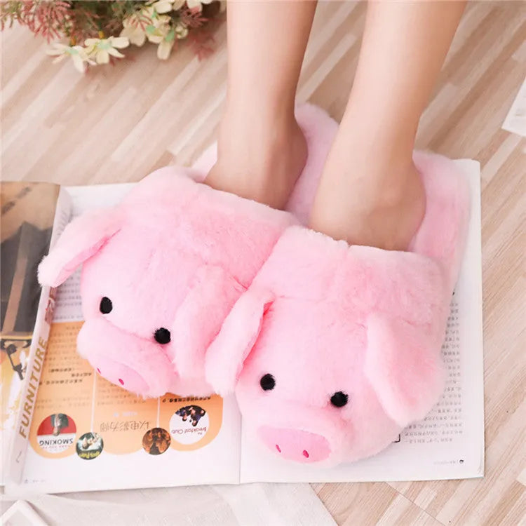 Pink adult pig-shaped floor slippers with short plush fabric on a white background.