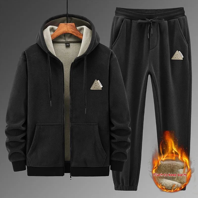 Man wearing a grey hooded sweater and matching trousers from a casual sports suit set.
