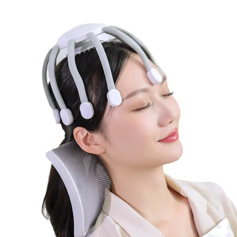Black electric head massager with multiple silicone claws vibrating on scalp