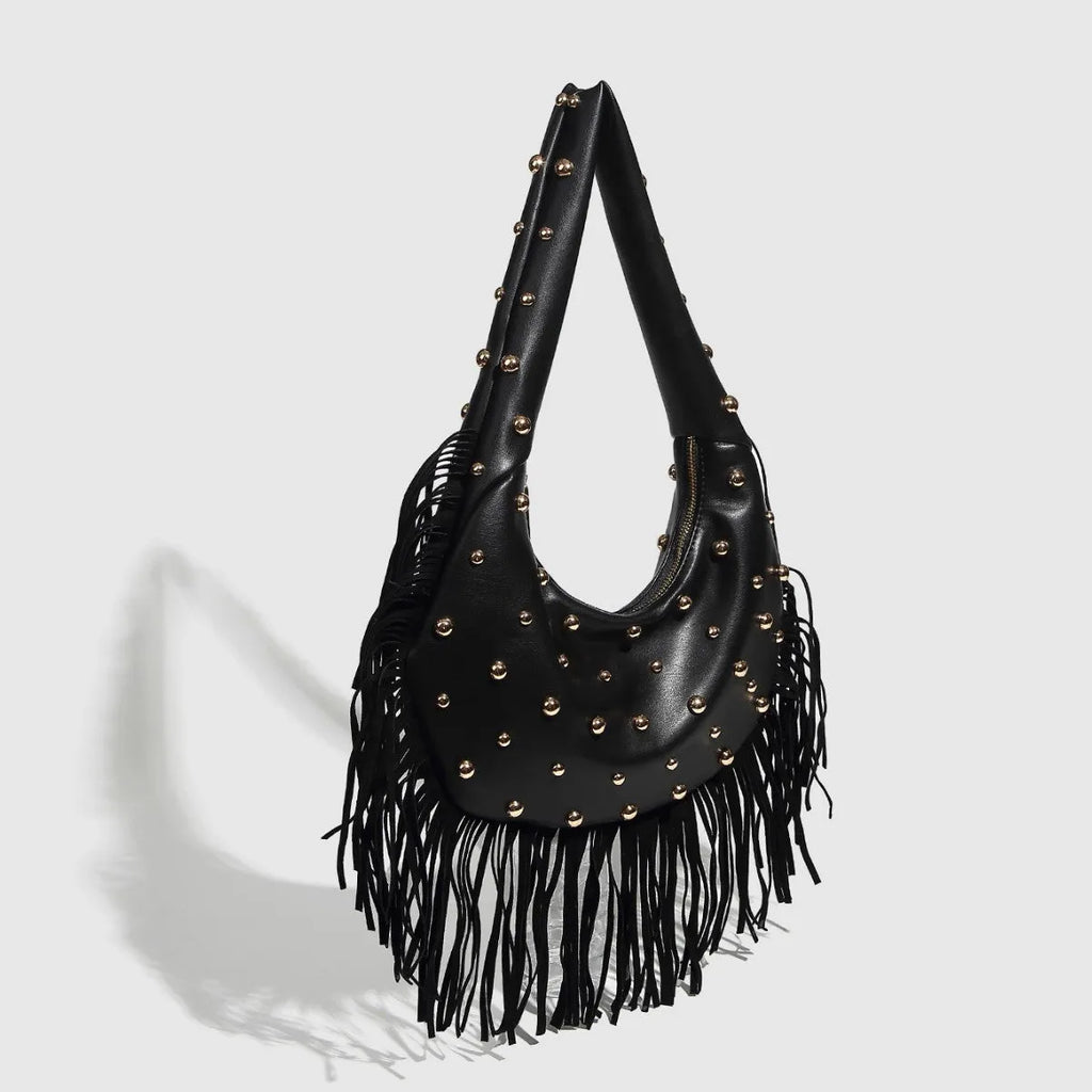 Retro tassel shoulder handbag in black colour showing decorative detail and shoulder strap
