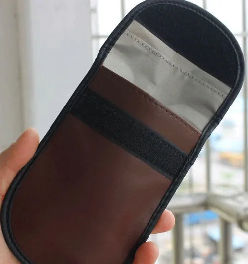 Black microfiber Faraday pouch for blocking car key fob and mobile phone signals.