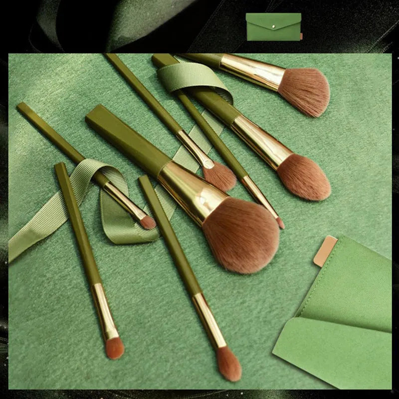 8-piece makeup brush set with man-made fibre bristles, wood handles, 17cm total length, and green shimmering PU bag