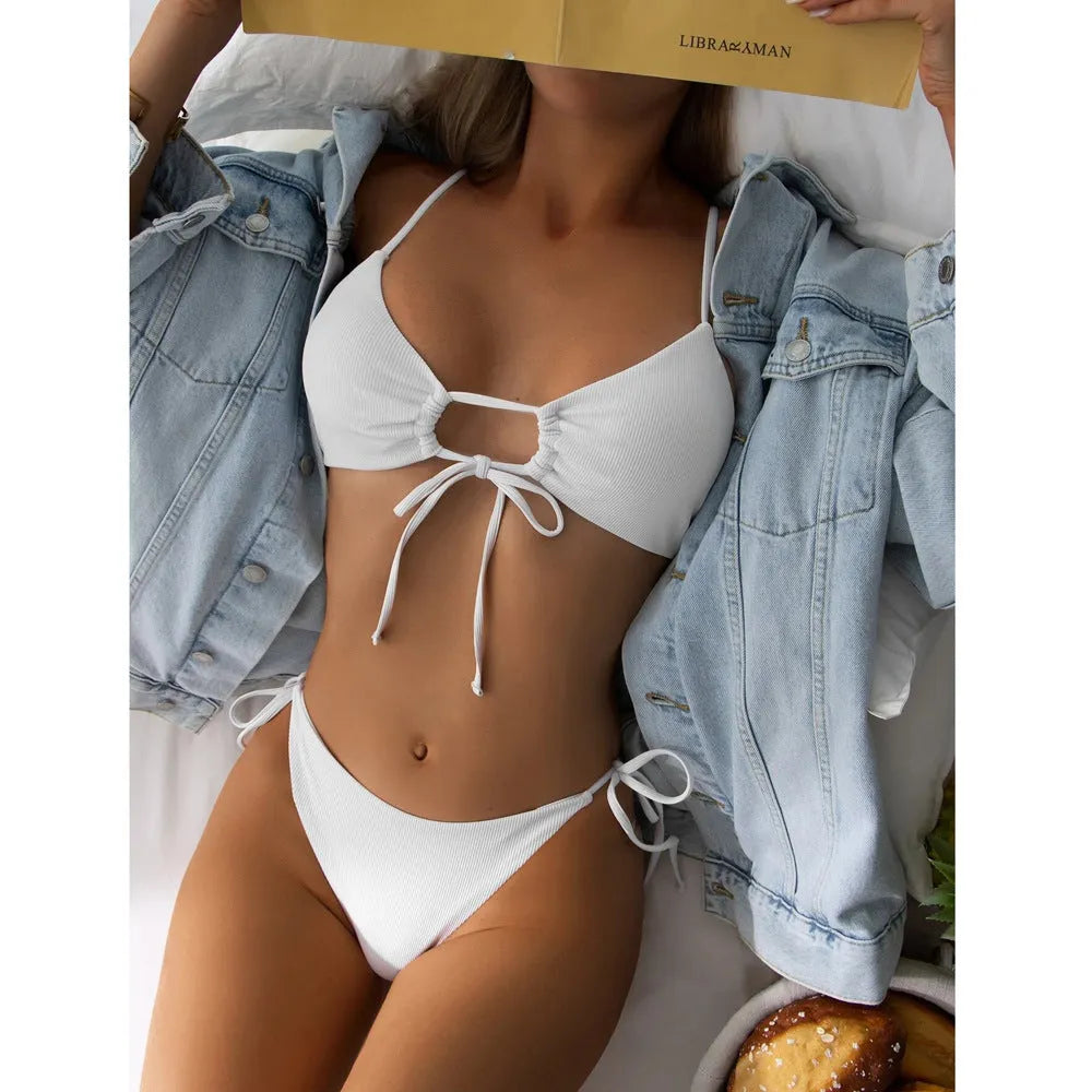 Women's solid colour drawstring bikini set in brief backless style on a neutral background.