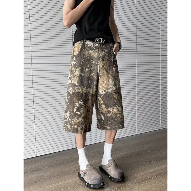 Yellow jeans with a snake camouflage pattern, shown in a cropped length.