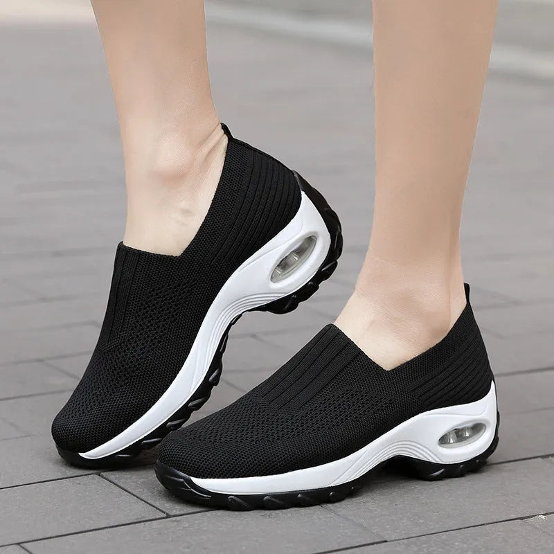 Women's mesh slip on air cushion sneakers in black, with low top and thick bottom, side view