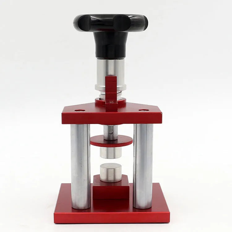 Watch back cover press tool, a spiral cap presser machine, shown with a set of 20 plastic moulds for different watch sizes.