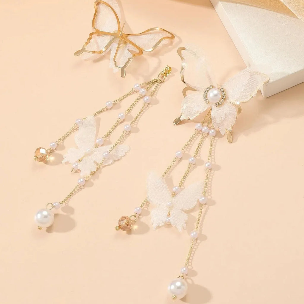 White butterfly-shaped tassel earrings with pearls and sparkling rhinestones on a copper alloy base.