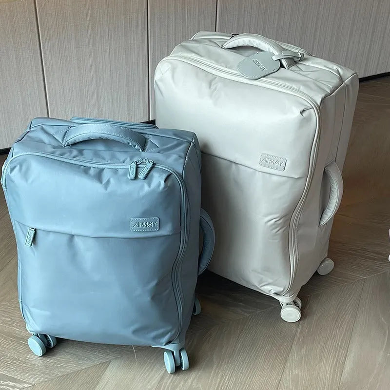 Ultra-light waterproof Oxford cloth suitcase in bluestone green with universal wheels, shown with a 24-inch size example.