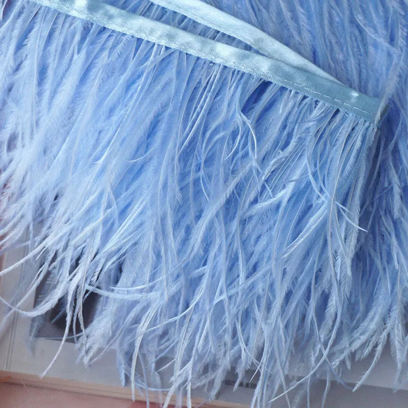 Decorative feather cloth strip in multiple colours including white, black, and mint green for DIY clothing and craft projects