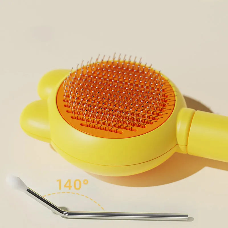 Self-cleaning cat brush with release button showing stainless steel teeth with rubber tips