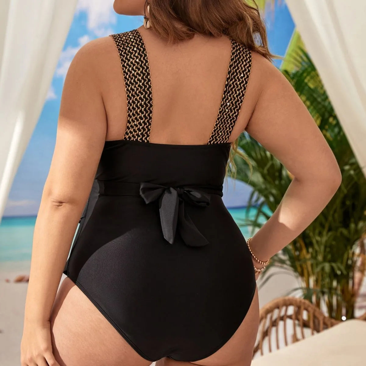 Woman wearing a plus size dark red one-piece swimsuit with built-in chest pads.