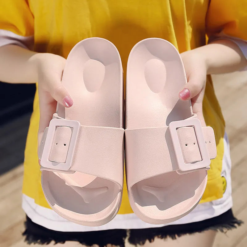 Women's grey blue EVA flip-flop sandals with a buckle strap on a white background.