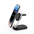 Clear folding wireless charger showing three internal coils, propped upright charging a mobile phone.