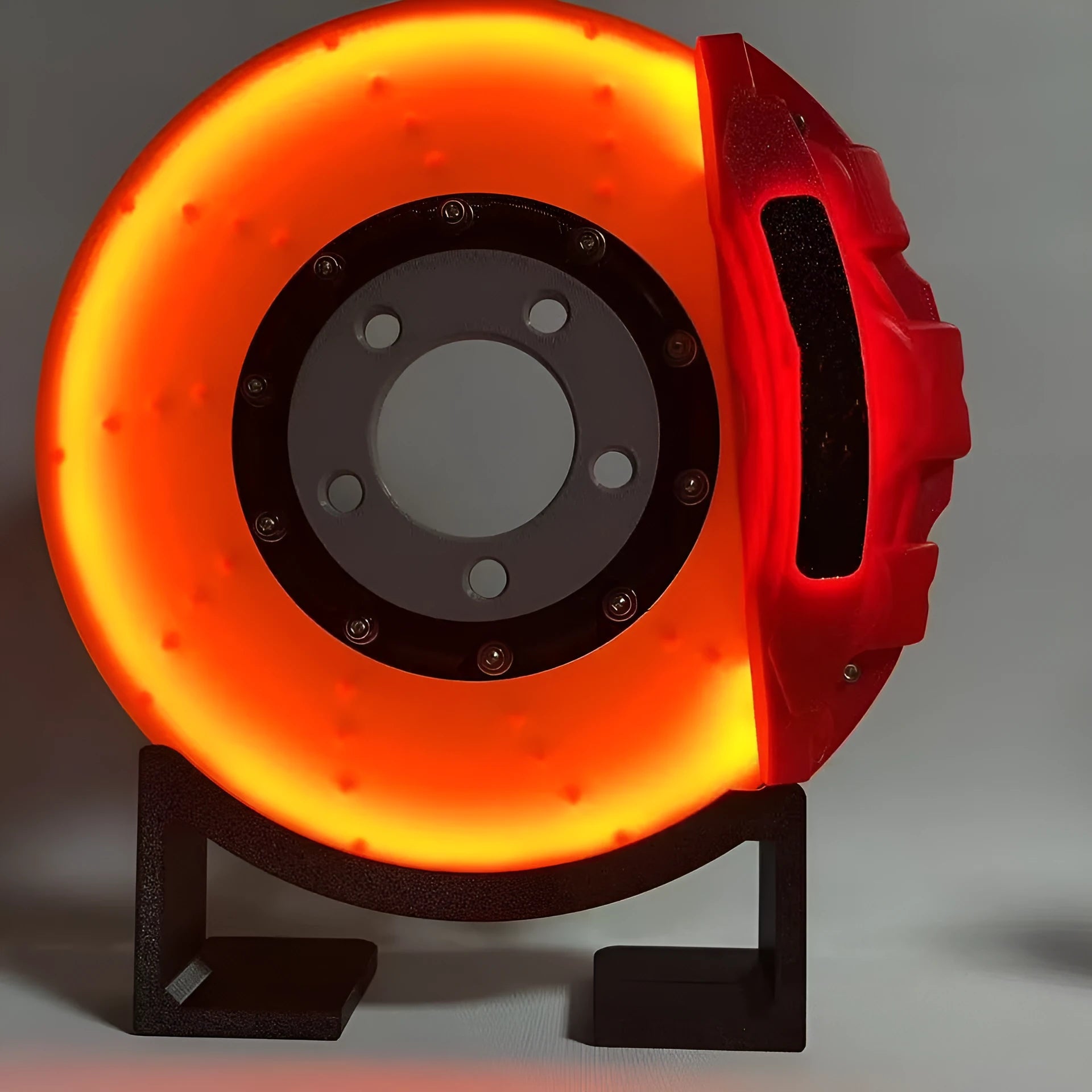 Brake disc design rechargeable LED night light with touch control in blue, red or yellow.