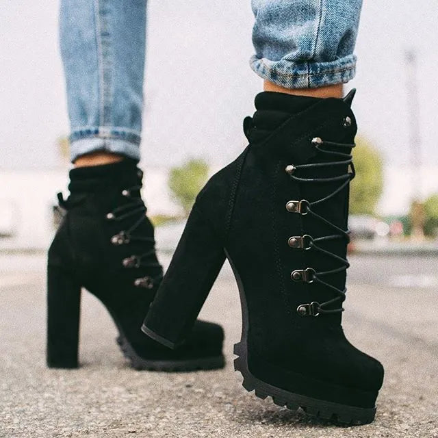 Women's army green suede Roman boots with high thick heels, a platform sole, and decorative rivets.