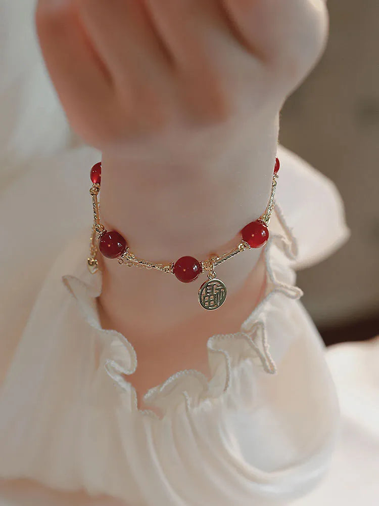 Red agate and alloy double-layer women's bracelet with Hongma lucky charm pendant on wrist