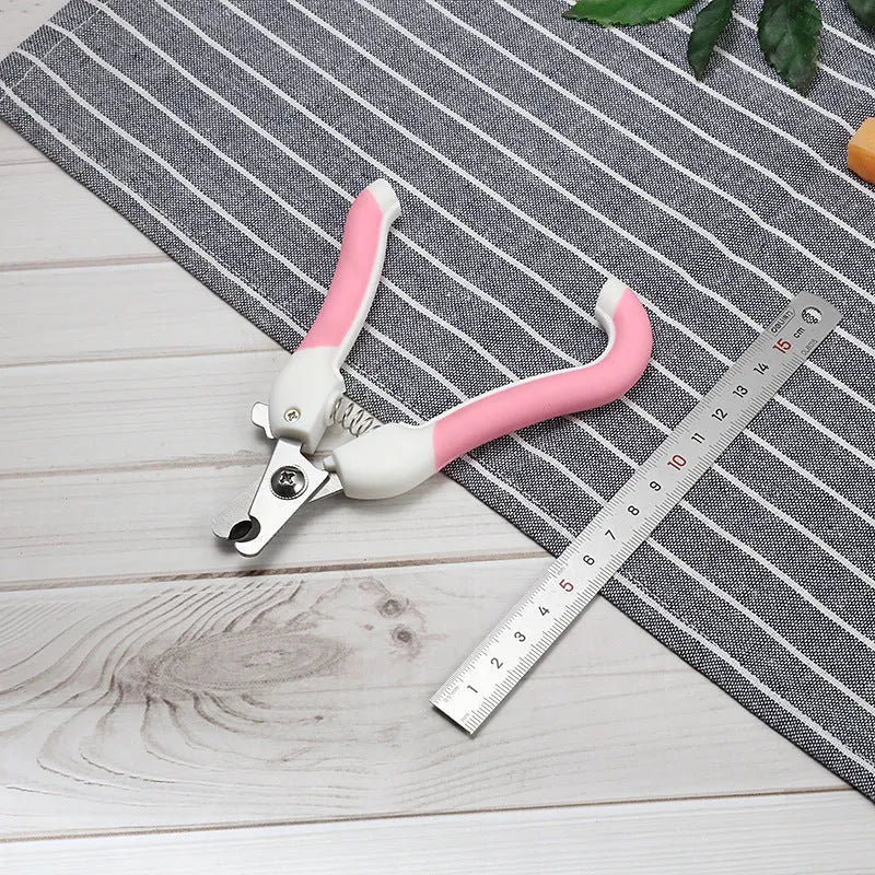 Pet nail scissors with stainless steel cutter head and curved handle in blue or pink, small or large, for dogs and cats