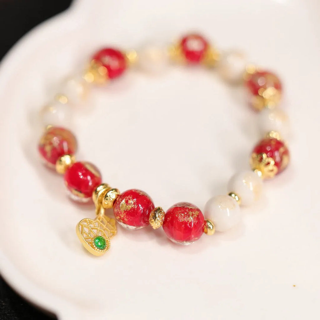 Women's ethnic geometric bracelet with gold foil decoration on glass and coloured glaze in two colour options.