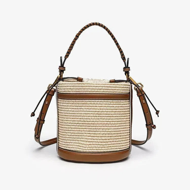 Brown PU leather bucket bag with woven texture, dual handles, and contrast stitching on a neutral background