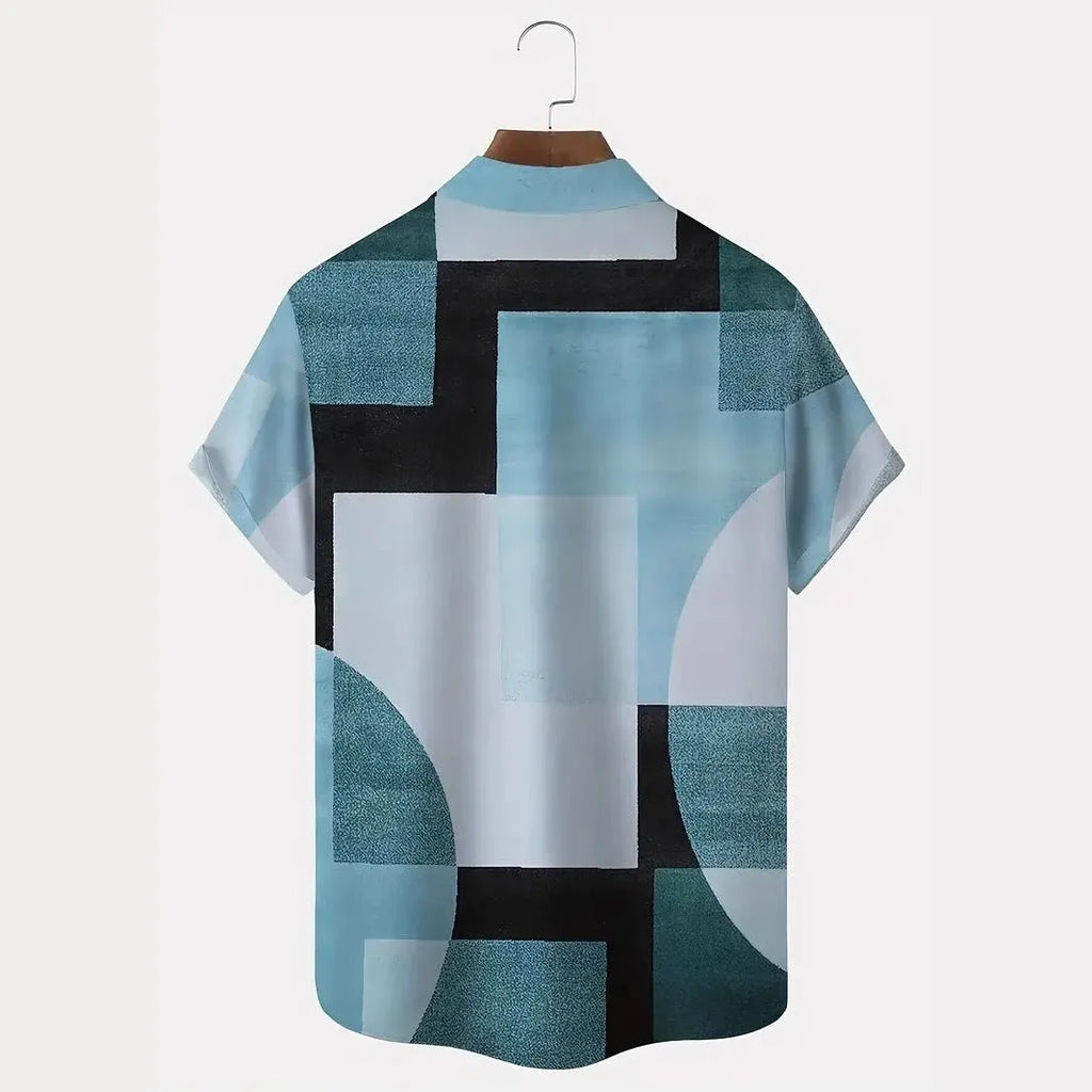 Man wearing a loose-fit short sleeve cardigan shirt with a blue and white 3D printed geometric square pattern.