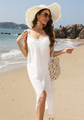 White women's crochet beach dress with a bottom slit, shown on a hanger.