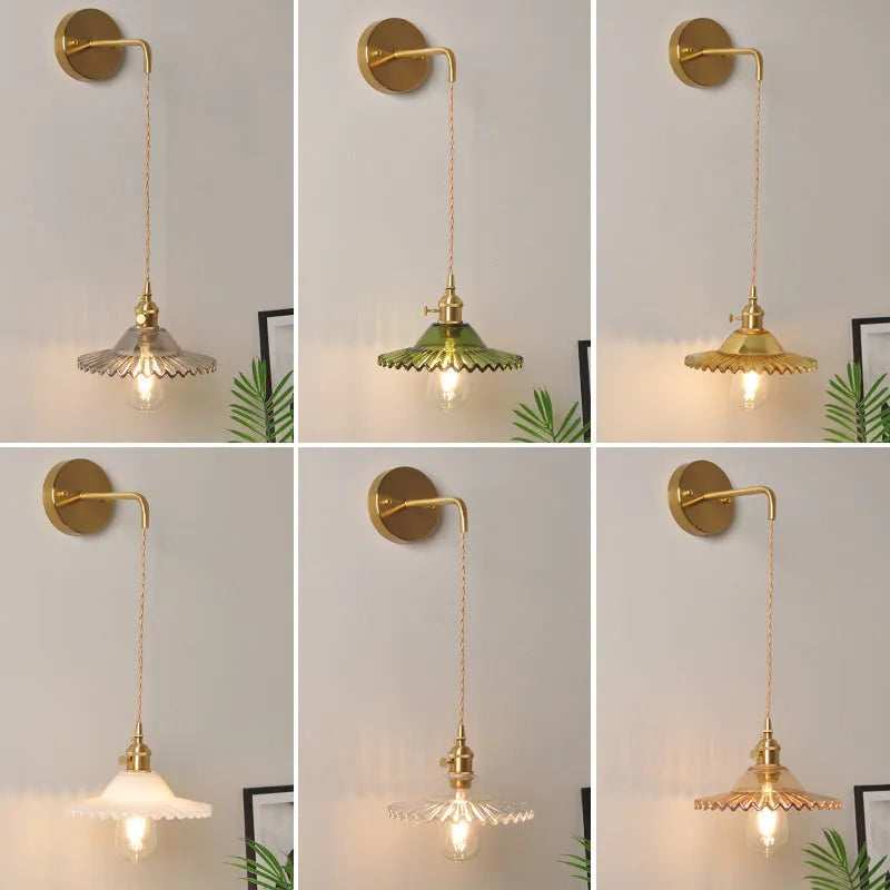 Retro brass wall lamp with a white glass lotus flower shade mounted on a beige wall.