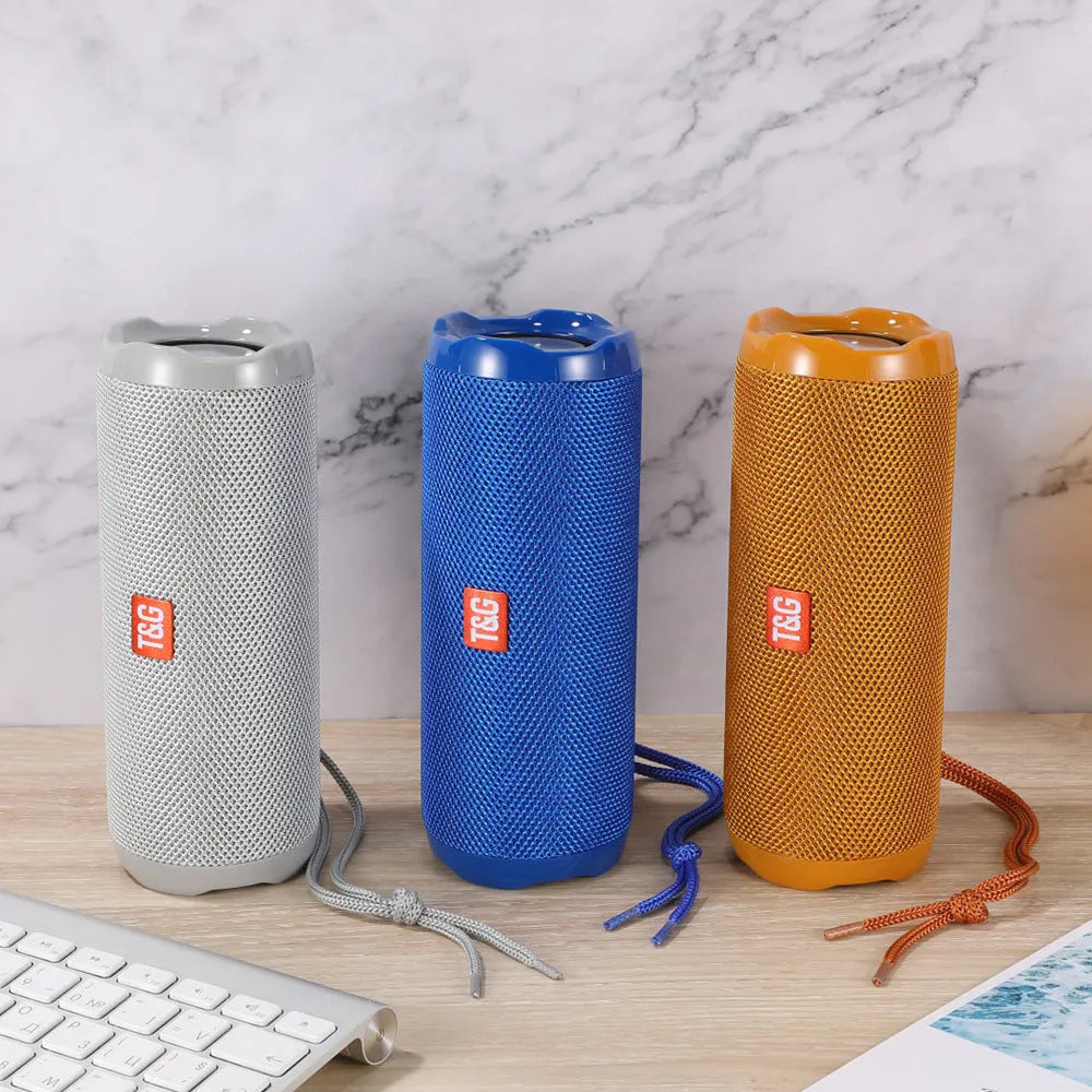 Fabric-covered portable Bluetooth speaker with a visible card slot in one of six colour options.