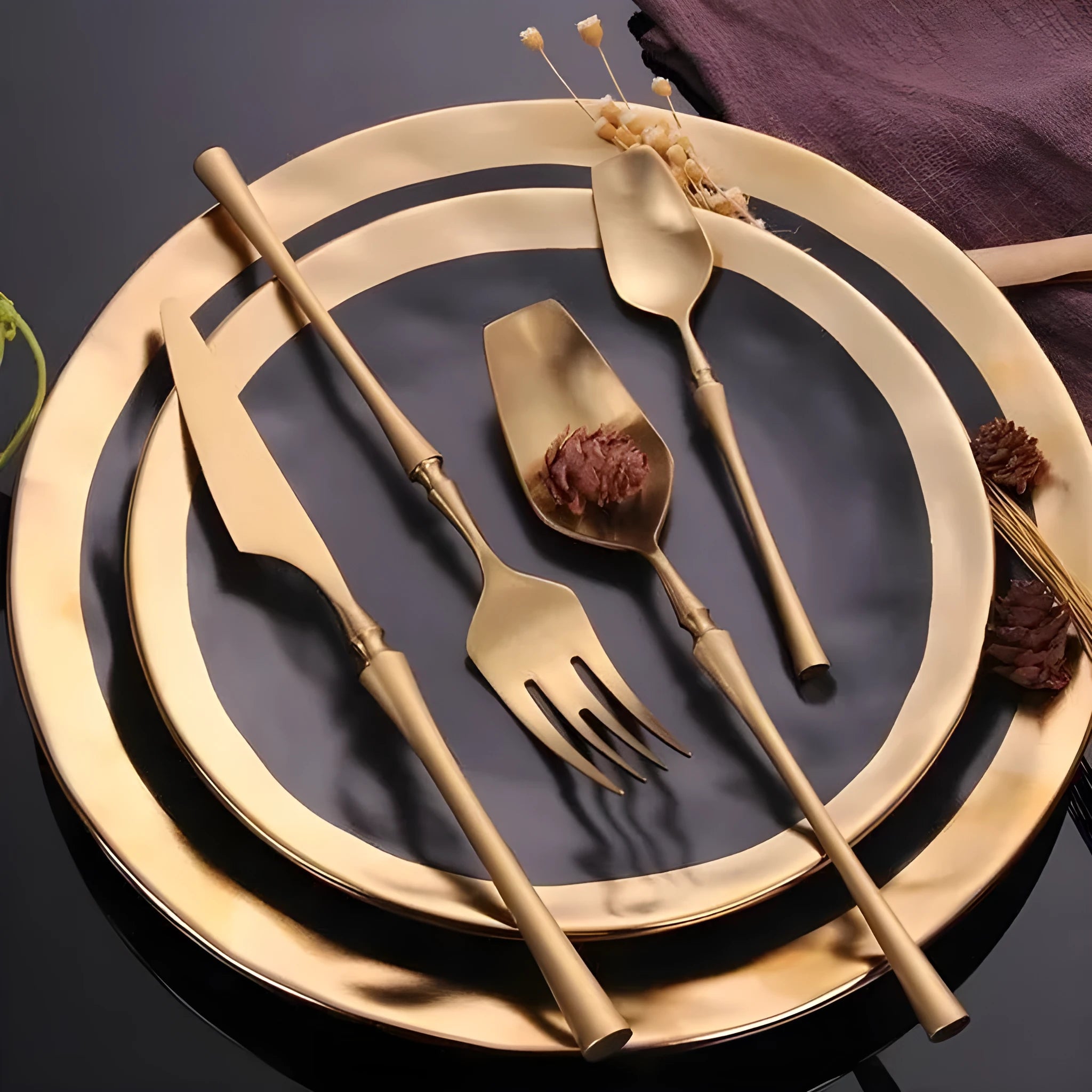 Stainless steel cutlery set with main knife, main fork, main spoon, and teaspoon in silver finish