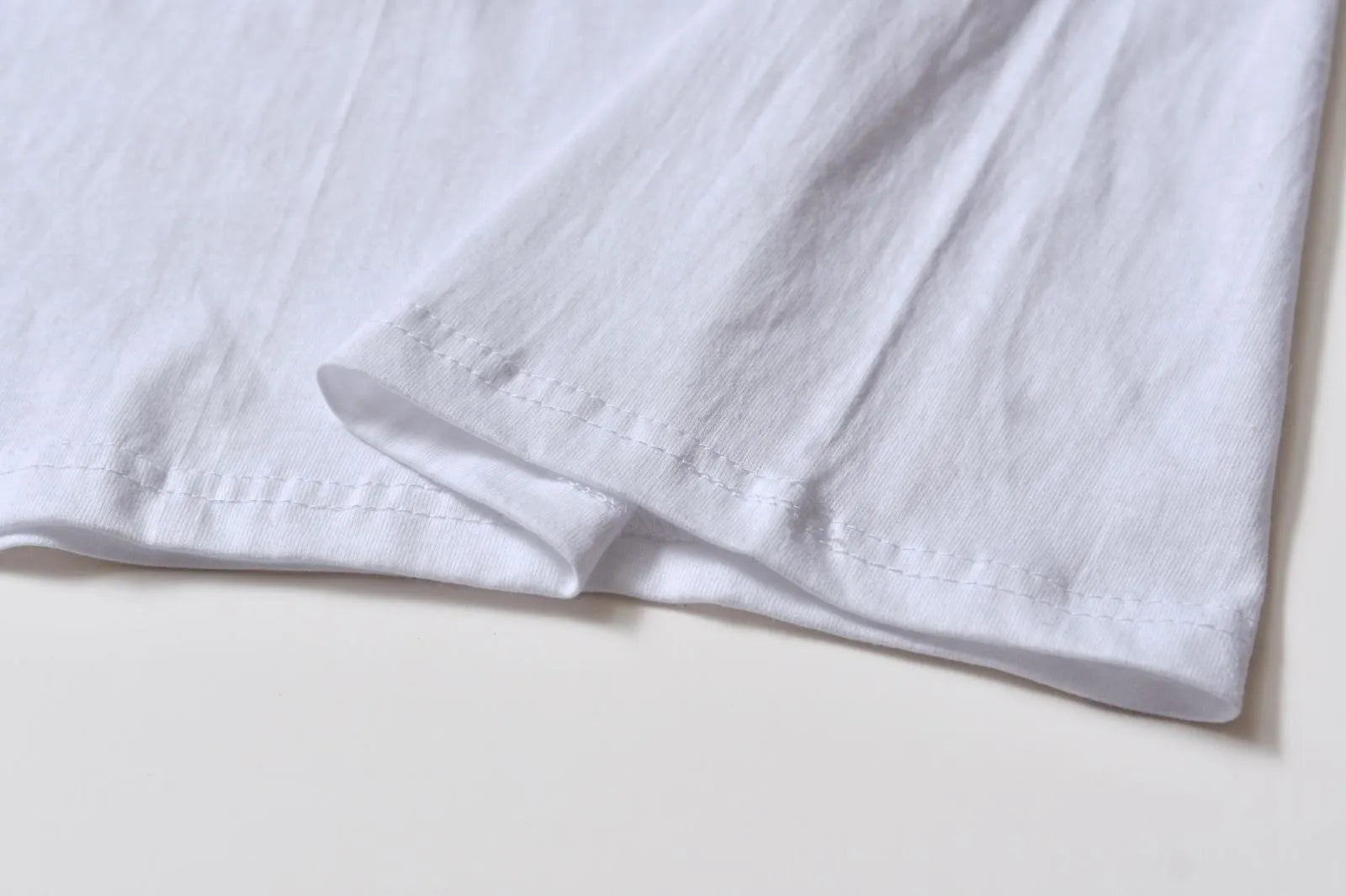 White cotton t-shirt overalls with short sleeves and a loose pullover fit