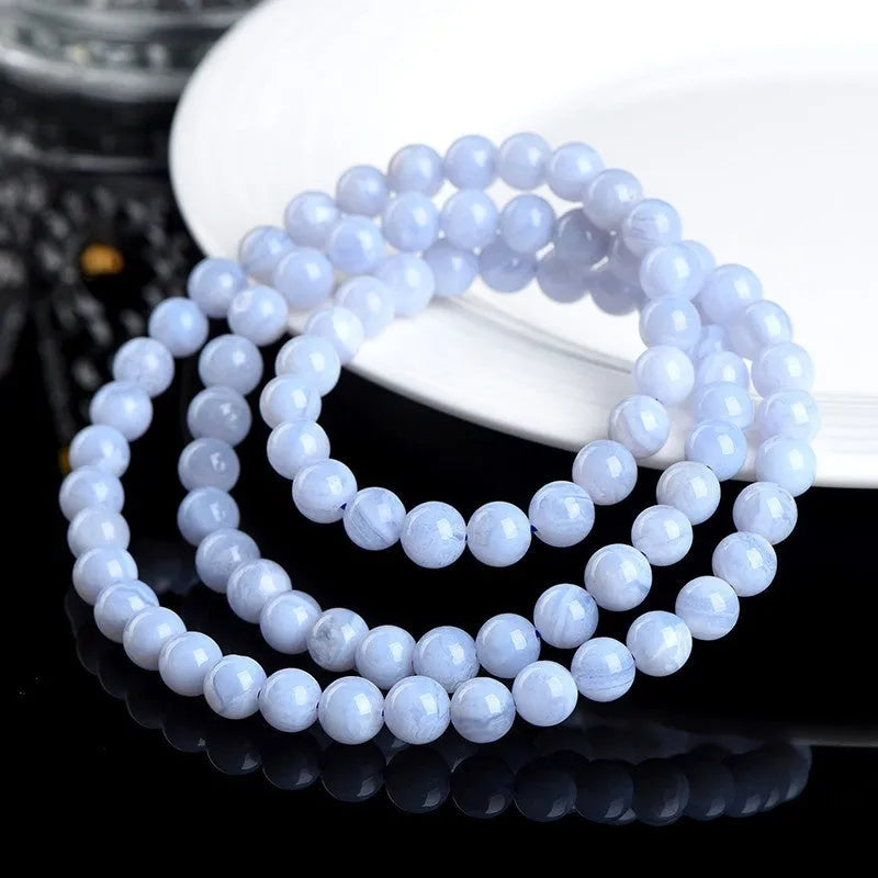 Blue agate beaded bracelet with three strands and a silver Ruyi-style clasp.