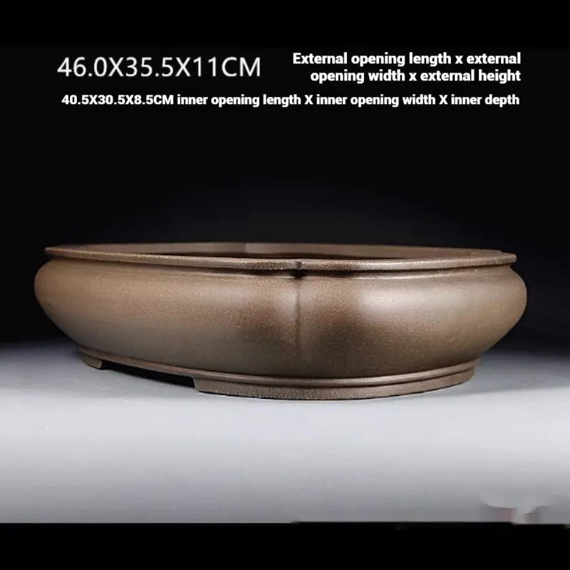 Handmade antique purple clay papaya-shaped flower pot shown from the side.
