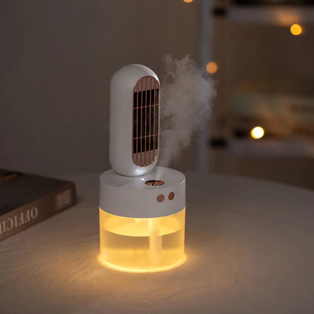 Small black and white personal humidifier fan with oscillating head on a desk