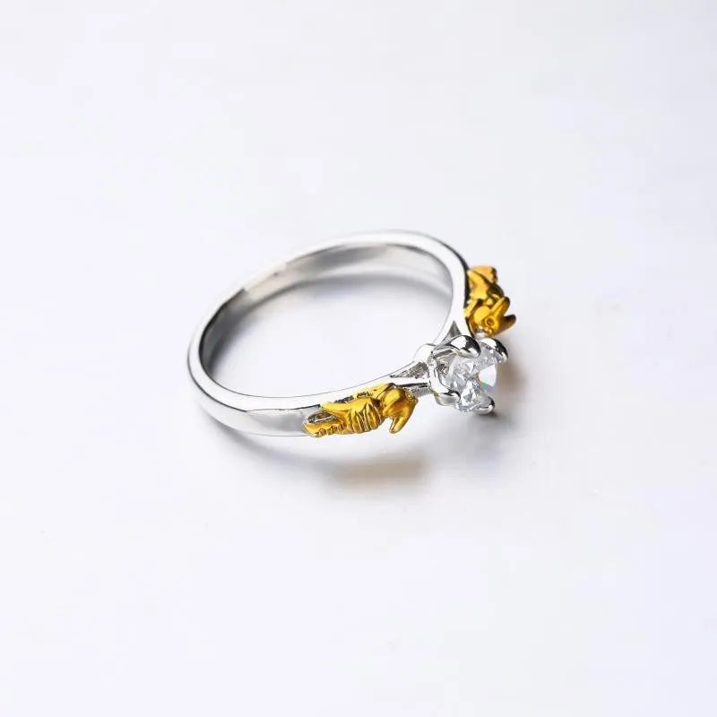 Close-up of a black gold copper ring with a detailed three-dimensional crown design on a finger.