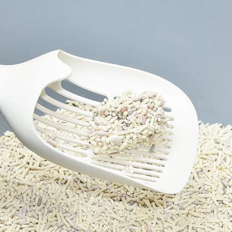 White plastic cat litter scoop with base on a clean surface, 29.5x12.8cm