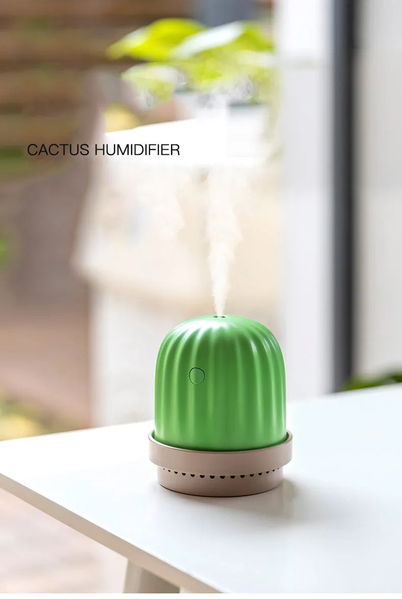 Cactus humidifier night light in green with colourful LED glow on a wooden desk