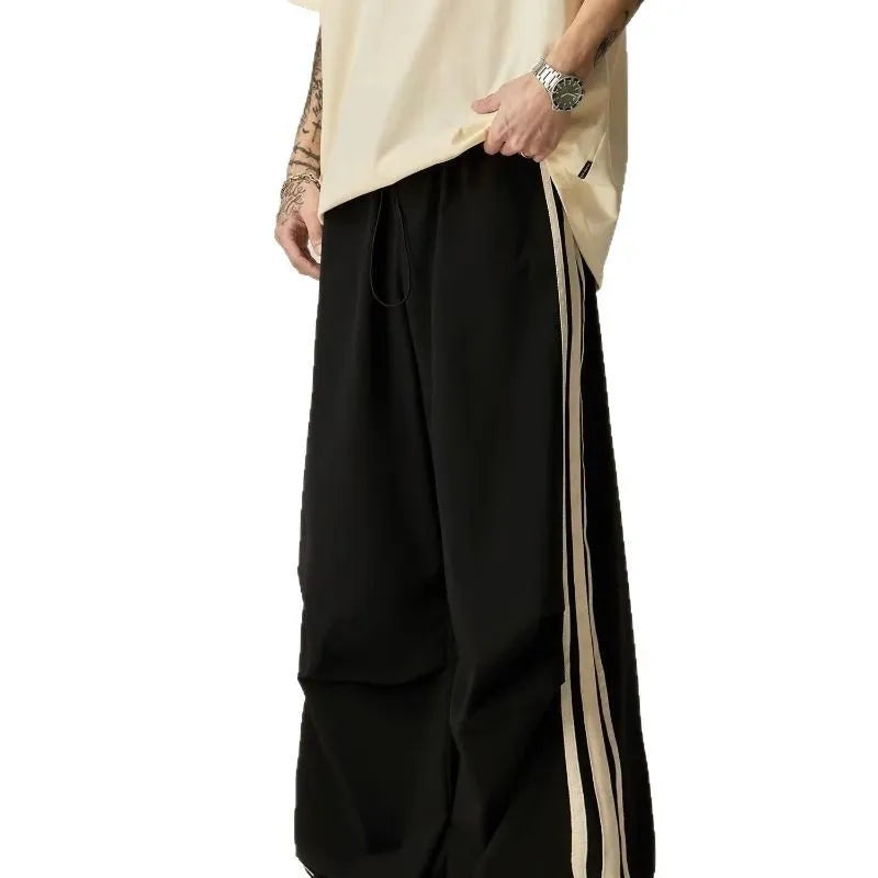 Black men's wide-leg climbing trousers with a high waist on a hanger.